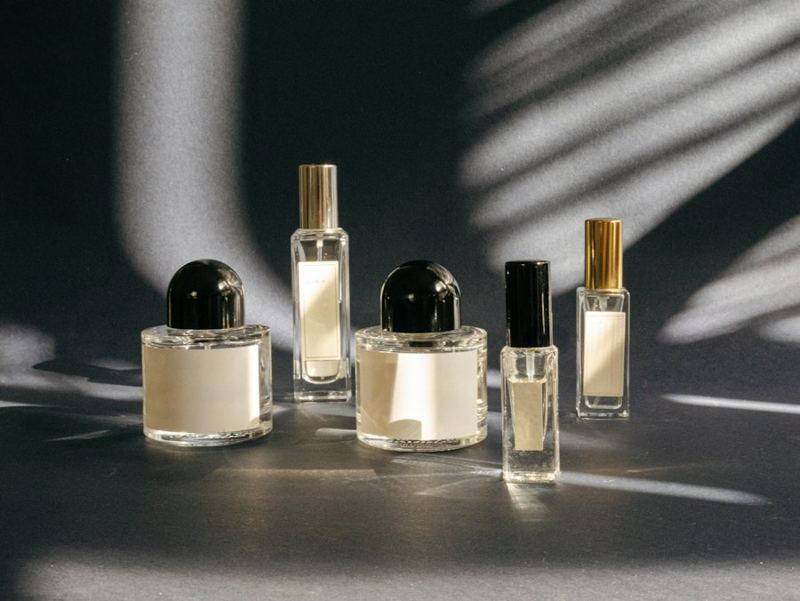 Small perfume bottles with black caps in hard light
