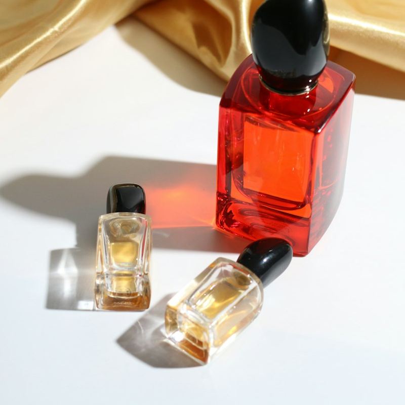 Red and gold perfume bottles on silk